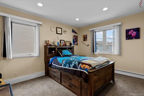 a bed sitting in a bedroom next to a window