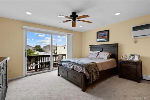 a spacious bedroom with a bed chandelier and a window