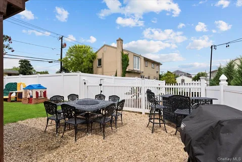 a view of a patio with a table and chairs