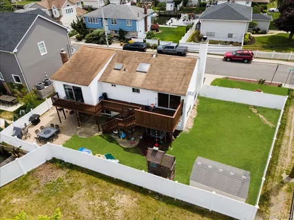 an aerial view of a house with swimming pool and outdoor seating