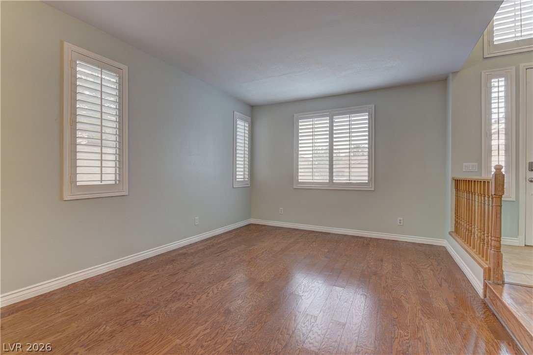 1813 Snow Spring Lane Las Vegas, NV 89134 - Photo 7 of 37 Hardwood flooring extends throughout this naturally illuminated, spacious room, offering versatile living possibilities.