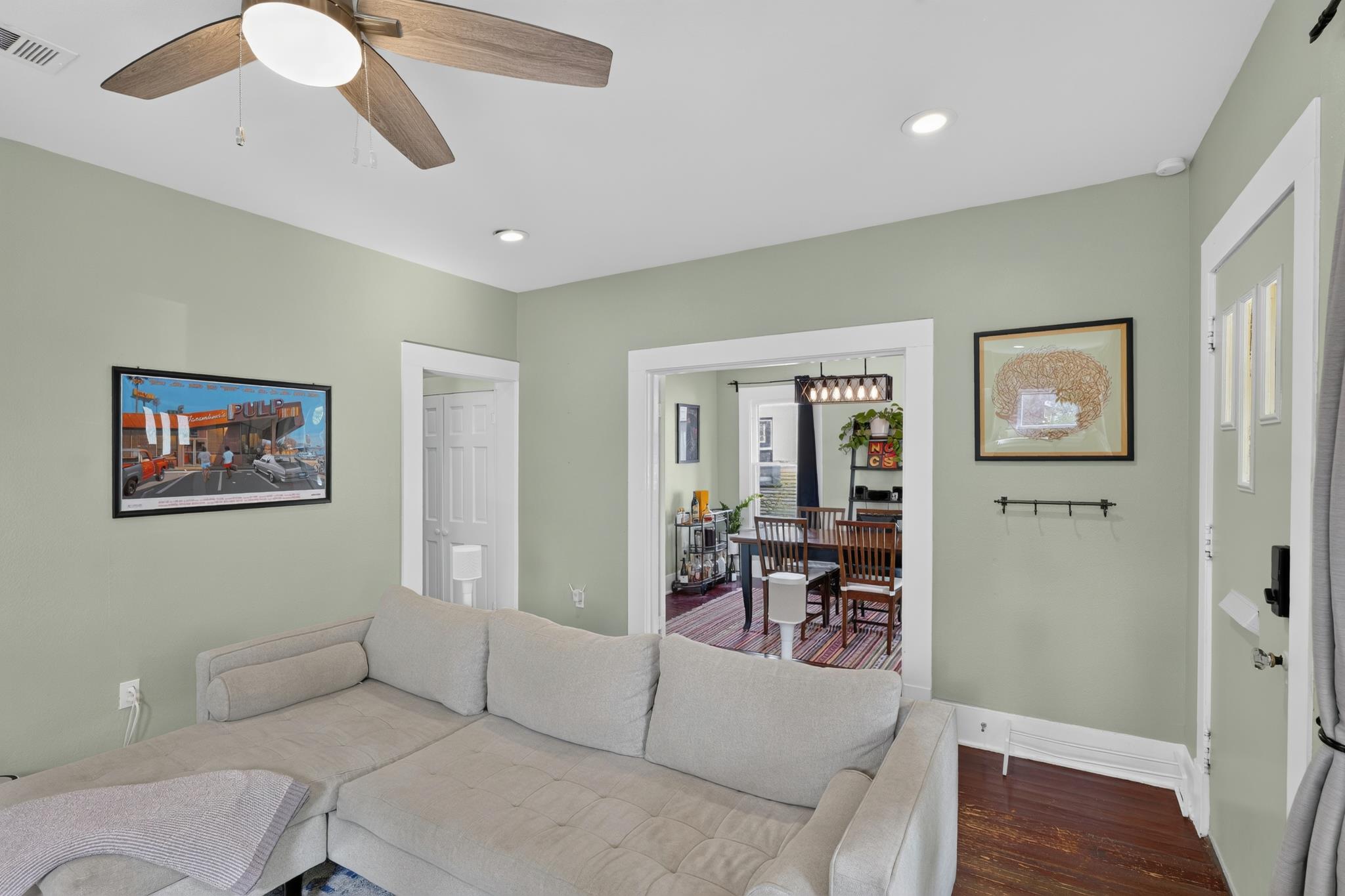 307 East 35th Street, Unit A Austin, TX 78705 - Photo 17 of 40 Hardwood flooring extends throughout this cozy living area, featuring recessed lighting and a ceiling fan.