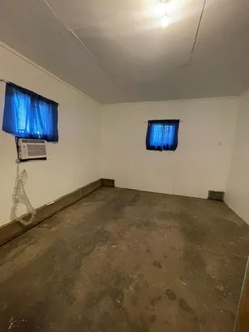 a view of an empty room and wooden floor