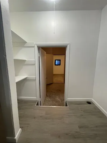 an empty room with an entrance to other room