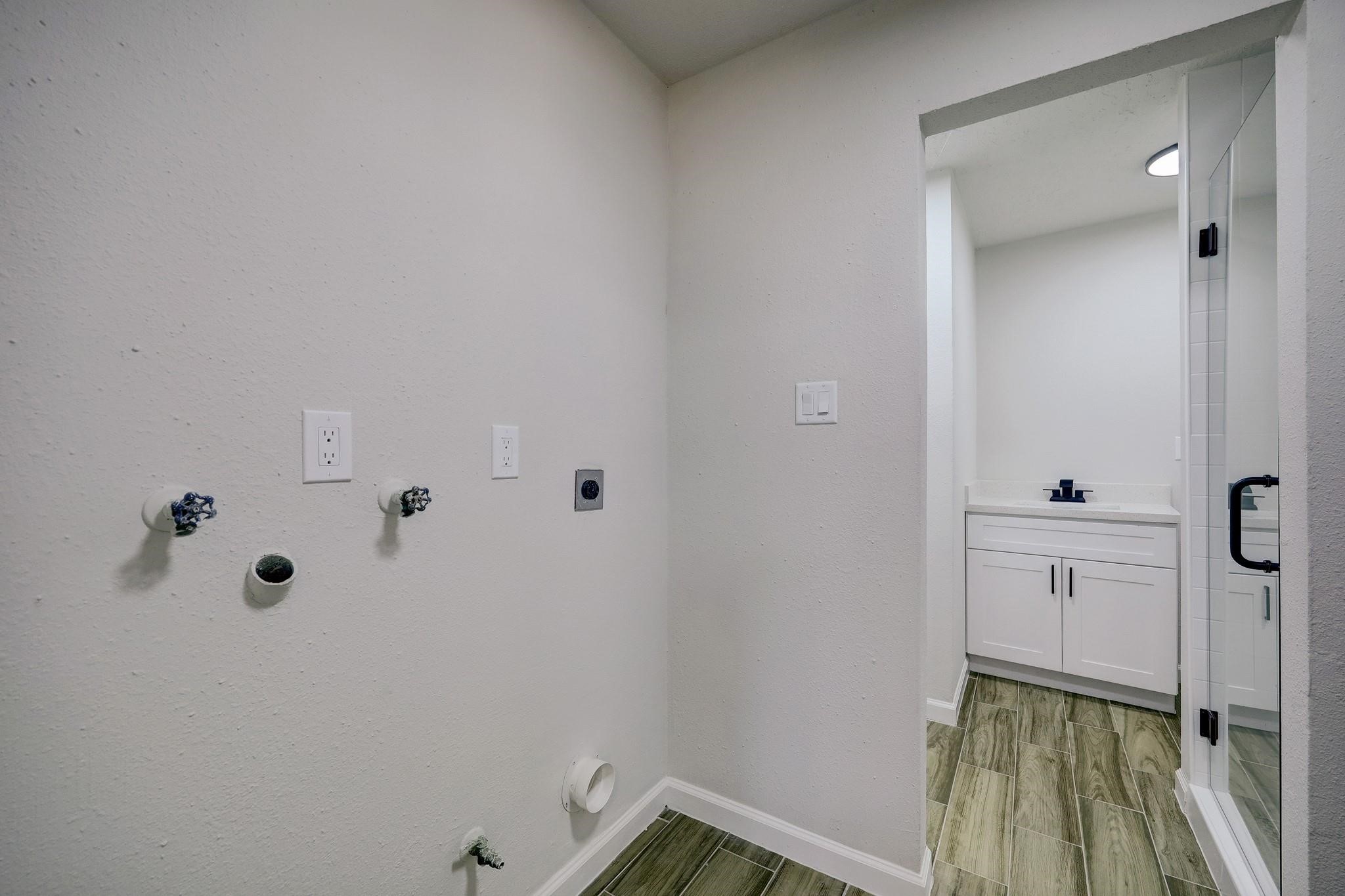 9723 Galston Lane Spring, TX 77379 - Photo 14 of 24 A practical combination space that includes a dedicated laundry zone and full bathroom.