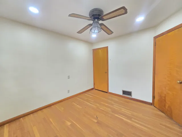 an empty room with a empty space and a ceiling fan