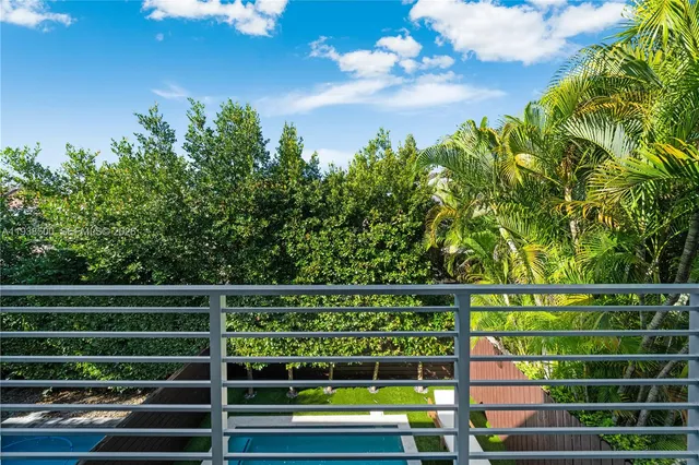 a balcony with trees in the back