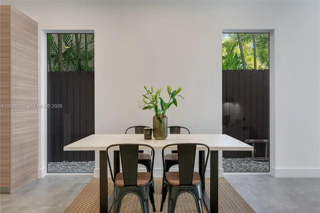 a view of a dining room with furniture and a potted plant