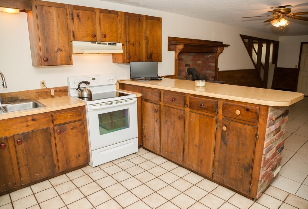 113 Cammett Road Barnstable, MA 02648 - Photo 8 of 28 a kitchen with stainless steel appliances a stove a sink and a refrigerator