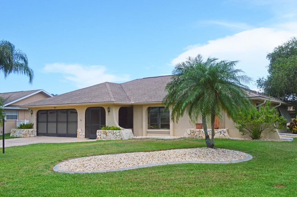 5852 Lincoln Road Venice, FL 34293 - Photo 1 of 1 a front view of a house with a garden