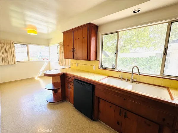 a kitchen with a sink and large window