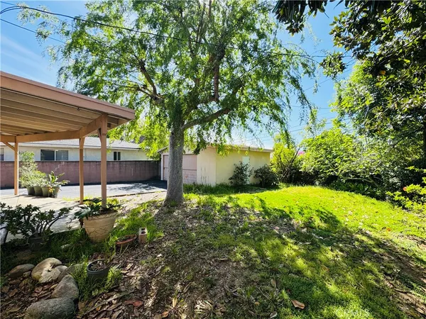 a backyard of a house with a yard and outdoor seating