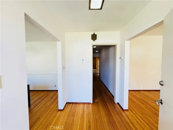 a view of a hallway with wooden floor