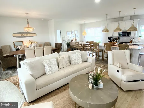 a living room with furniture kitchen and a chandelier