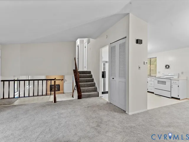 a view of a kitchen with white cabinets and a sink