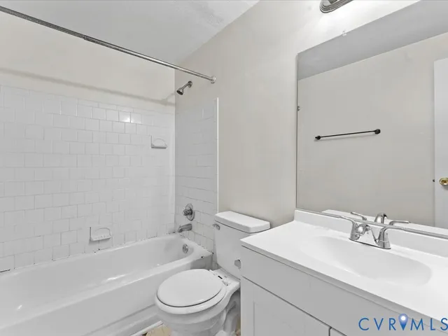 a bathroom with a sink toilet tub vanity and shower