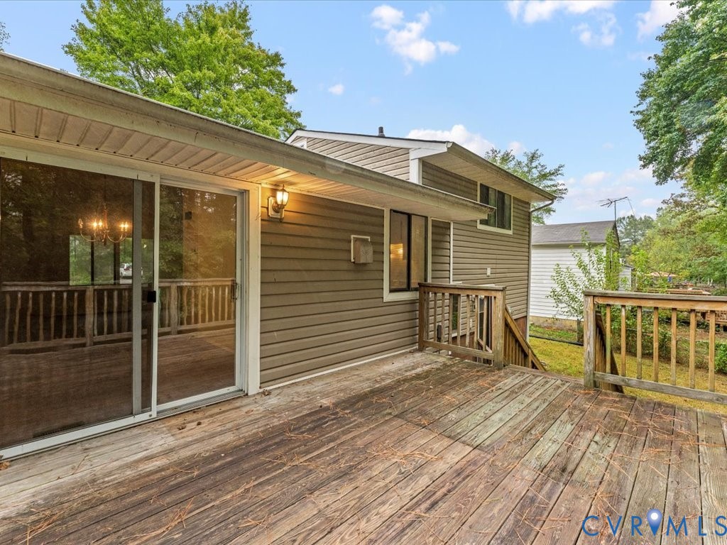 9611 Kennesaw Road Chesterfield, VA 23236 - Photo 7 of 20 a view of a house with a wooden deck and a floor to ceiling window