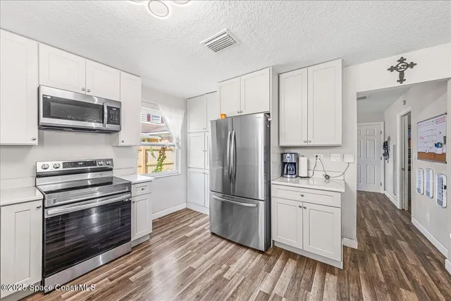 a kitchen with wooden cabinets and stainless steel appliances