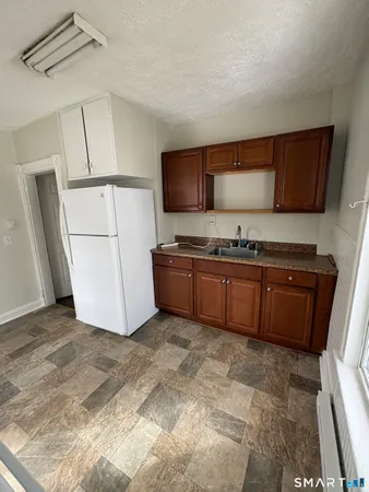 a kitchen with a sink and a refrigerator