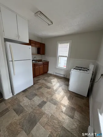 a kitchen with stainless steel appliances a refrigerator and a stove top oven