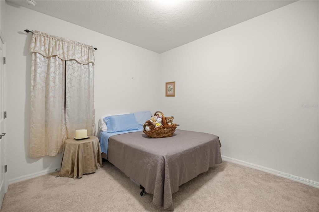 6474 Southwest 89th Loop Ocala, FL 34476 - Photo 15 of 34 a bedroom with a bed and a table