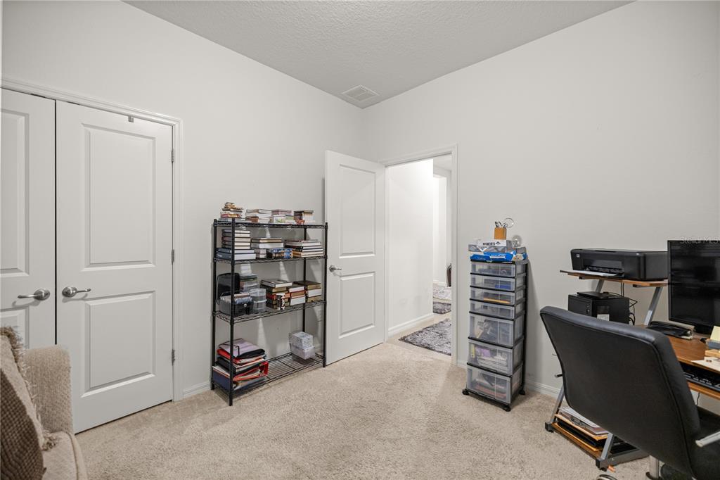 6474 Southwest 89th Loop Ocala, FL 34476 - Photo 17 of 34 a view of a workspace with furniture and a cabinet