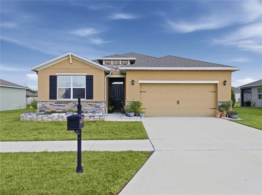 6474 Southwest 89th Loop Ocala, FL 34476 - Photo 27 of 34 a front view of a house with garden