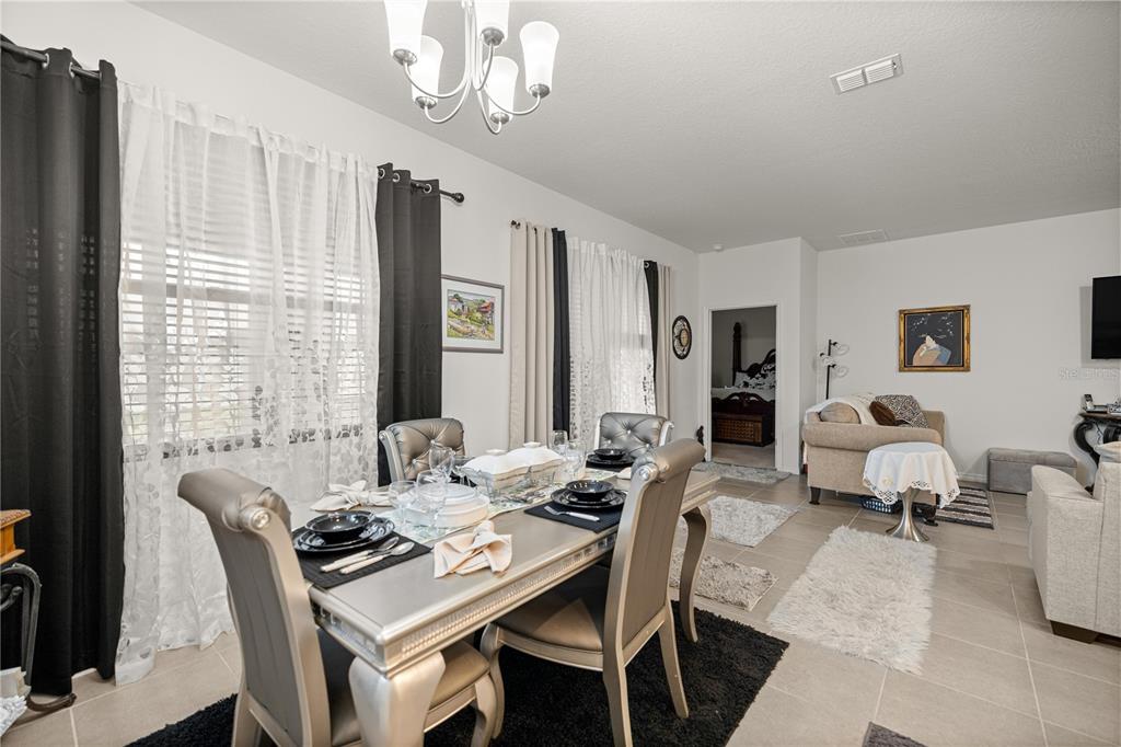 6474 Southwest 89th Loop Ocala, FL 34476 - Photo 6 of 34 a view of a dining room with furniture window and wooden floor