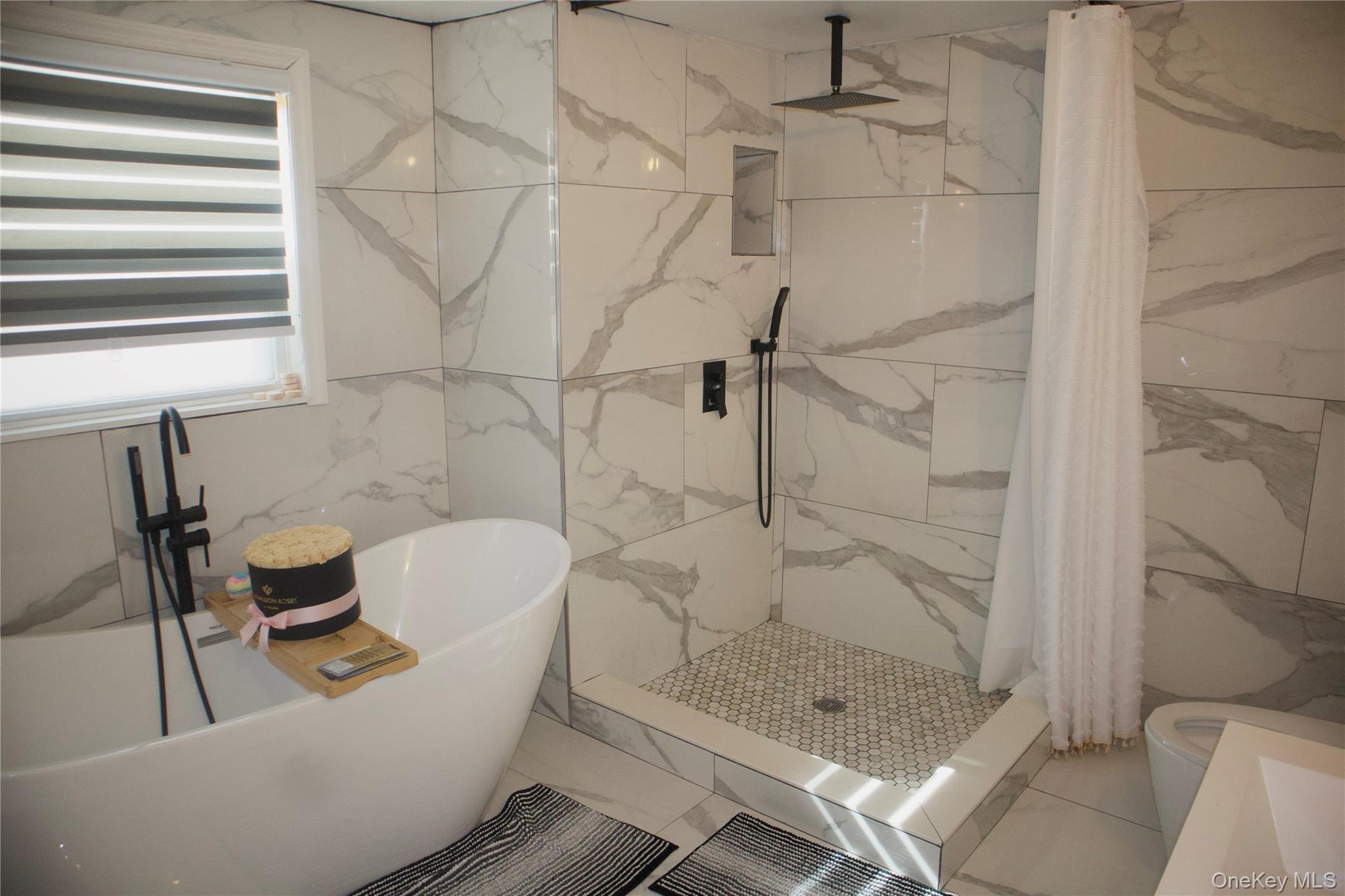 147-15 223rd Street Queens, NY 11413 - Photo 11 of 21 a bathroom with a shower a toilet and sink