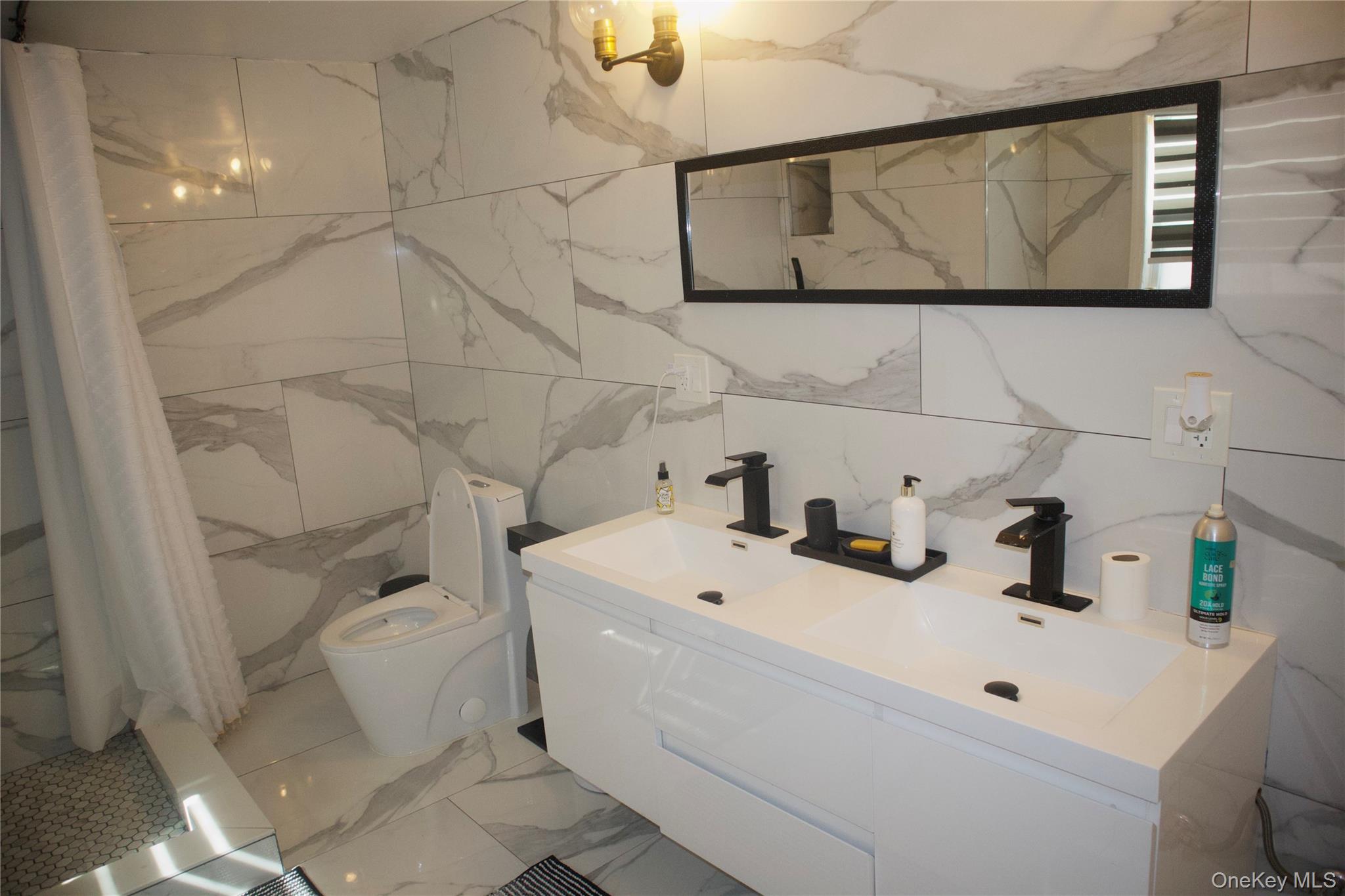 147-15 223rd Street Queens, NY 11413 - Photo 12 of 21 a bathroom with a sink and mirror
