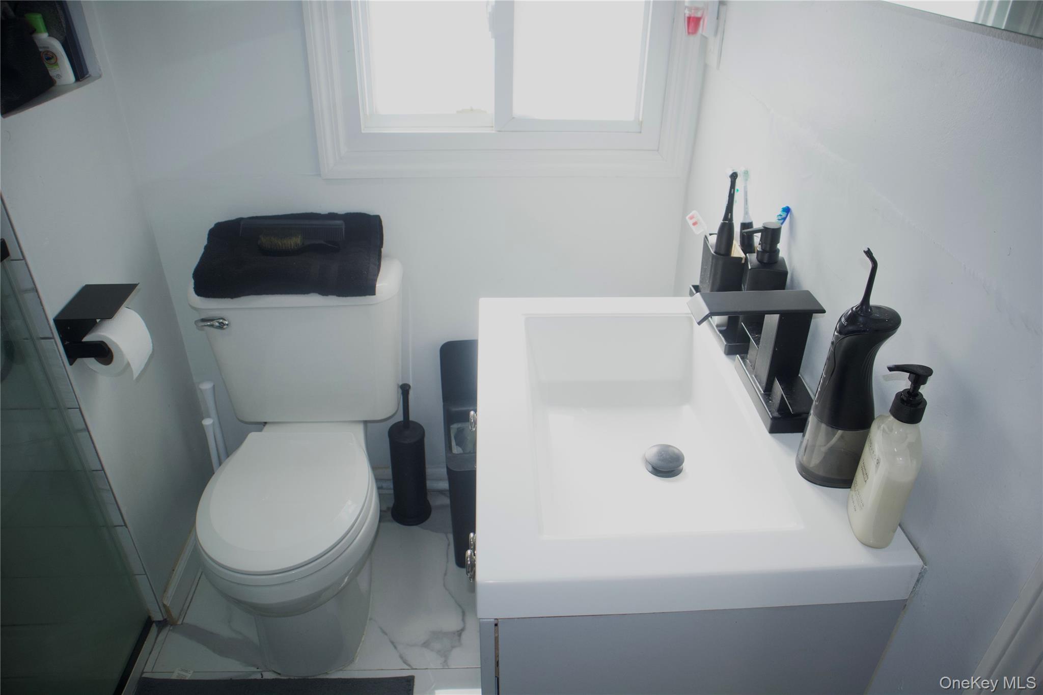 147-15 223rd Street Queens, NY 11413 - Photo 17 of 21 a bathroom with a toilet and a sink
