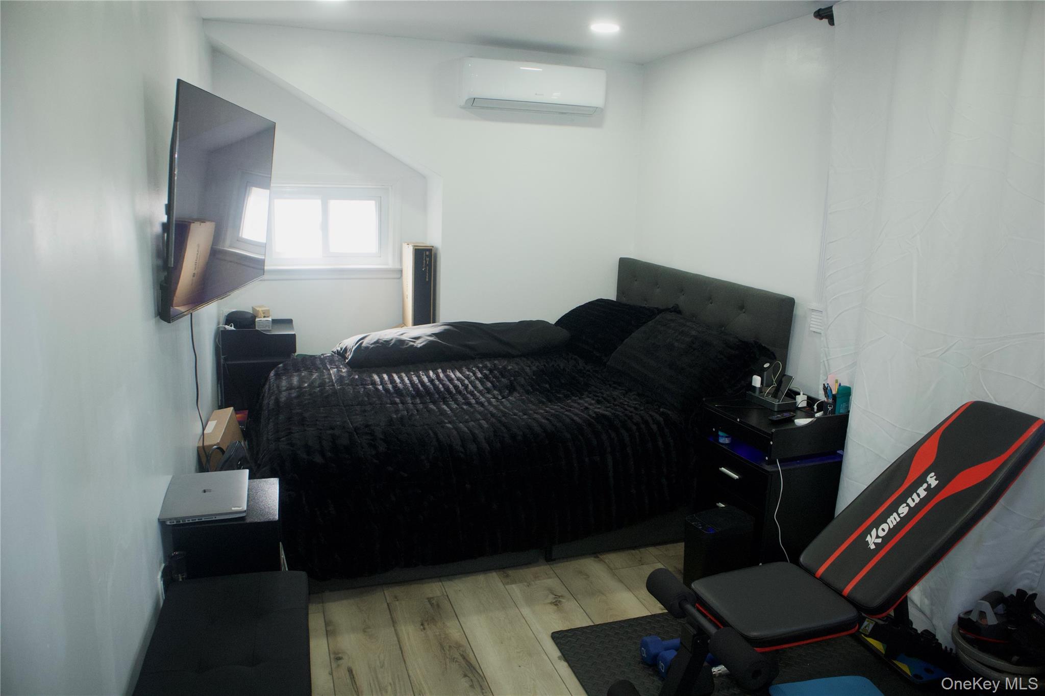147-15 223rd Street Queens, NY 11413 - Photo 20 of 21 a bedroom with furniture and a mirror