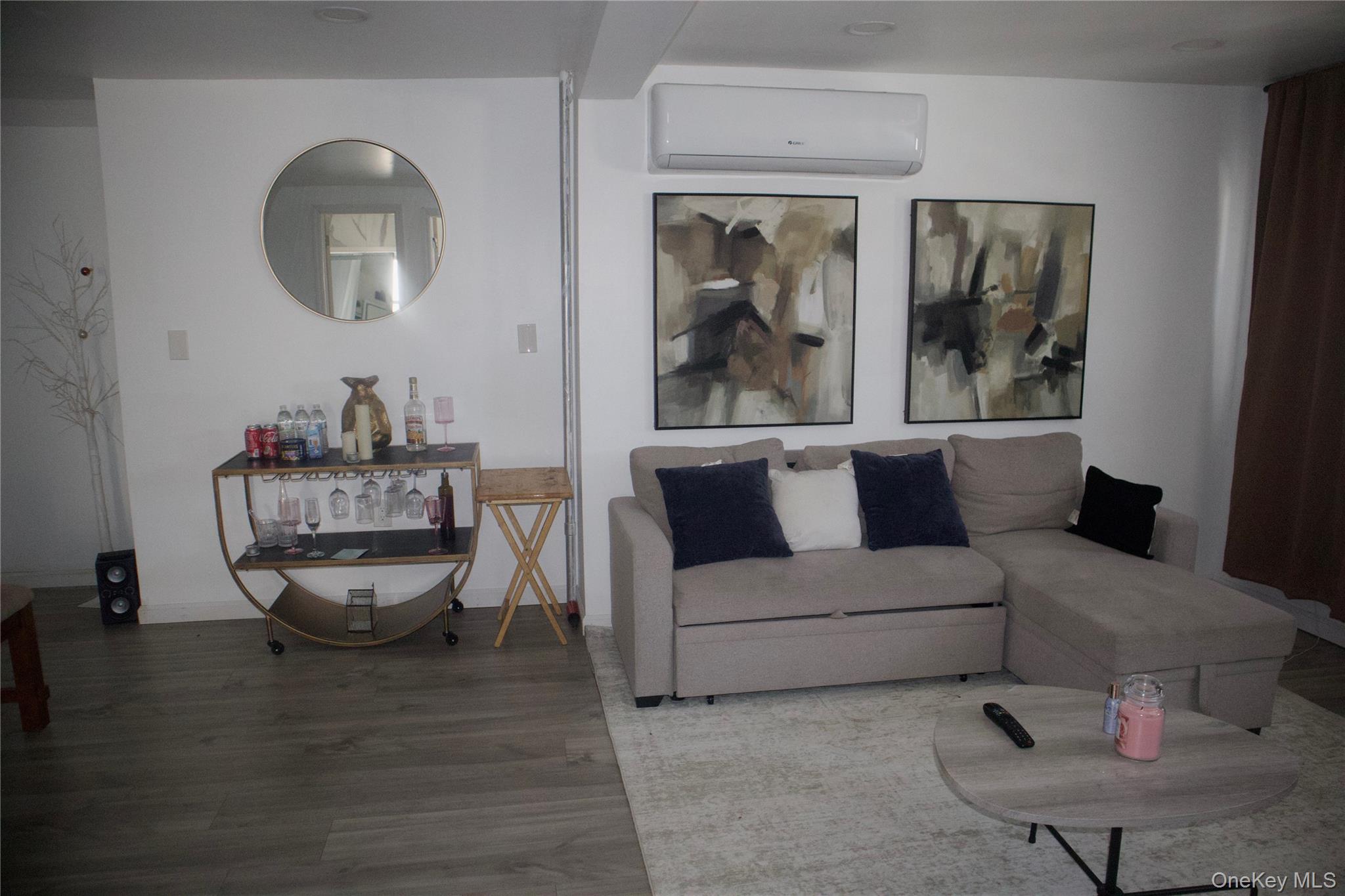 147-15 223rd Street Queens, NY 11413 - Photo 2 of 21 a living room with a couch and a window