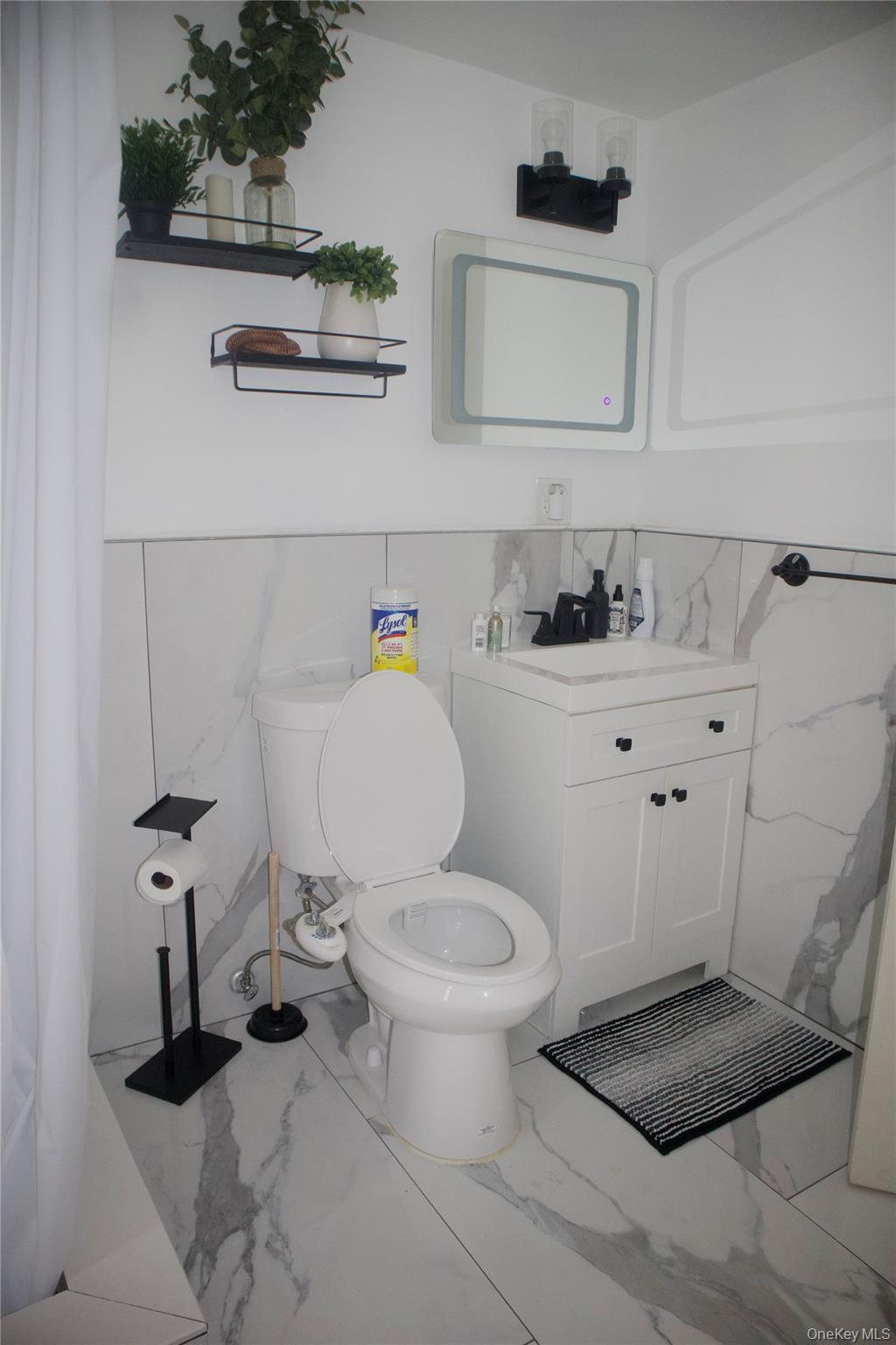 147-15 223rd Street Queens, NY 11413 - Photo 6 of 21 a bathroom with a toilet a sink and a window