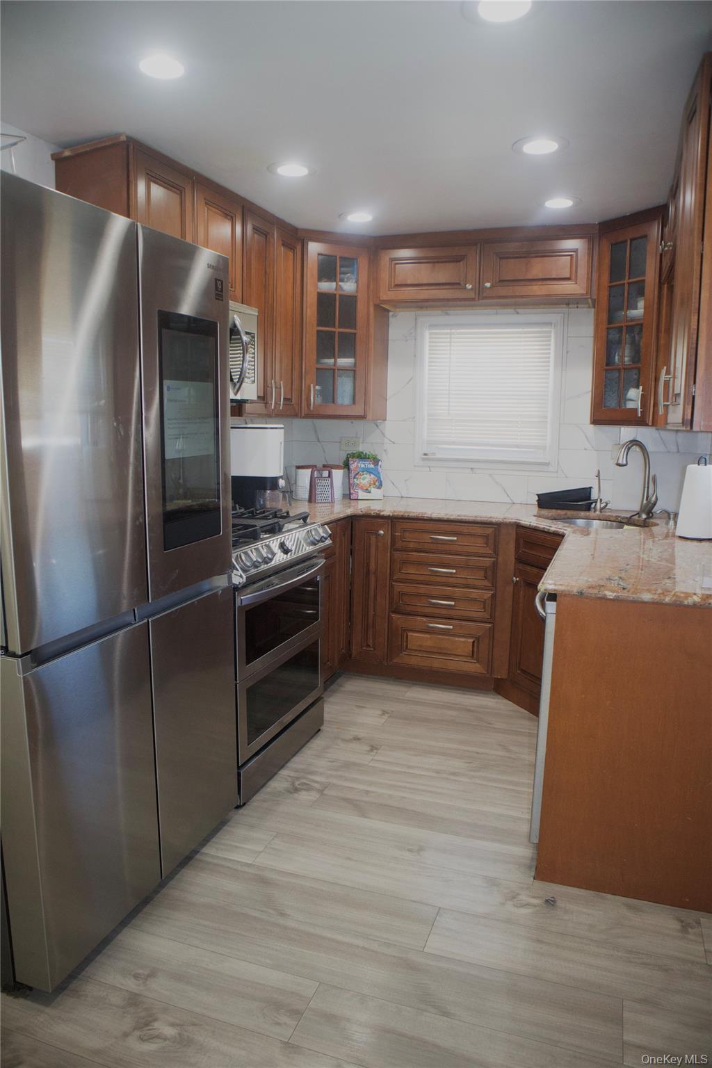 147-15 223rd Street Queens, NY 11413 - Photo 8 of 21 a kitchen with stainless steel appliances granite countertop a refrigerator a sink a stove a microwave and a refrigerator