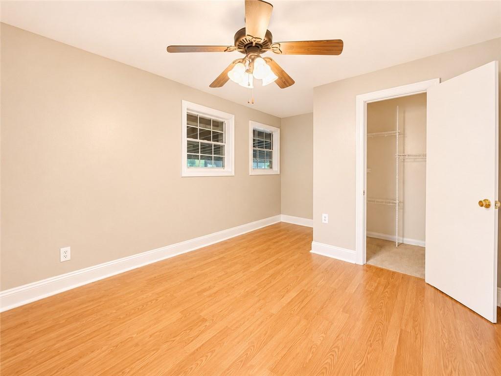 212 Craigtown Road Northeast Calhoun, GA 30701 - Photo 12 of 21 a view of an empty room with chandelier fan and wooden floor