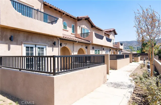 a view of a white building with many windows