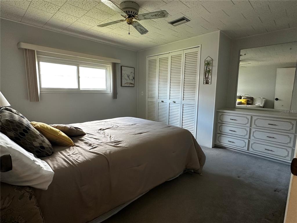 1100 South Belcher Road, Unit 523 Largo, FL 33771 - Photo 17 of 56 a bedroom with a bed and a dresser