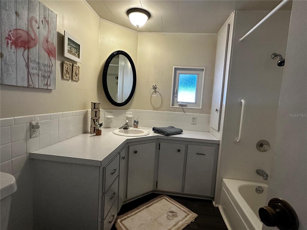 1100 South Belcher Road, Unit 523 Largo, FL 33771 - Photo 18 of 56 a bathroom with a double vanity sink a toilet and a mirror