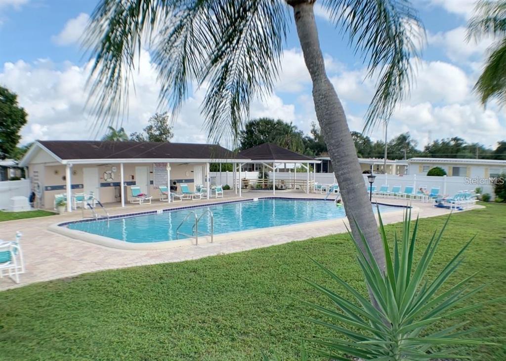 1100 South Belcher Road, Unit 523 Largo, FL 33771 - Photo 25 of 56 a view of a swimming pool with a garden