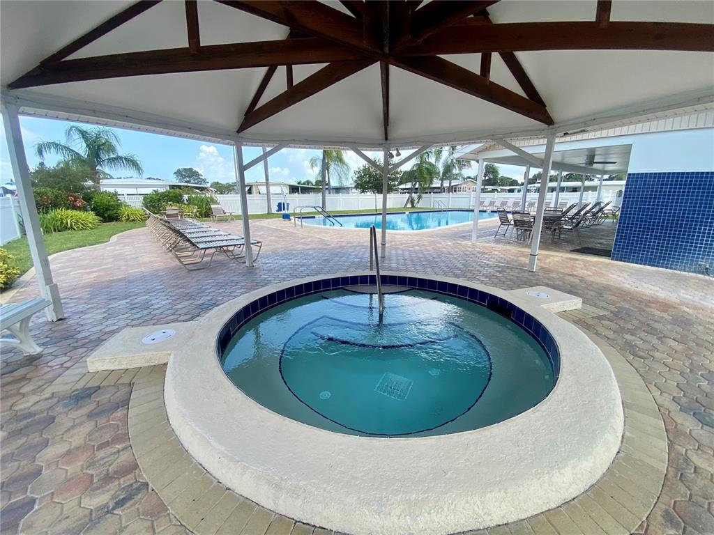 1100 South Belcher Road, Unit 523 Largo, FL 33771 - Photo 26 of 56 a view of a swimming pool with a porch