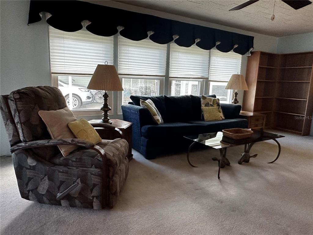 1100 South Belcher Road, Unit 523 Largo, FL 33771 - Photo 4 of 56 a living room with furniture a rug and a window