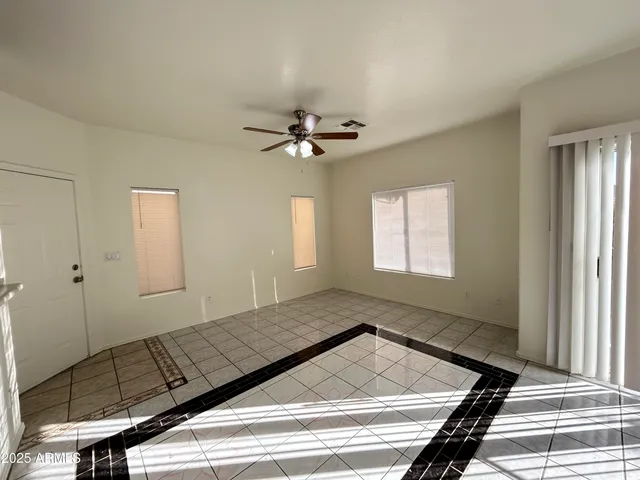a view of a living room with a ceiling fan