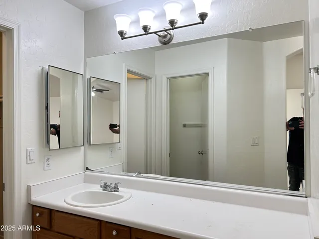 a bathroom with a sink and a mirror