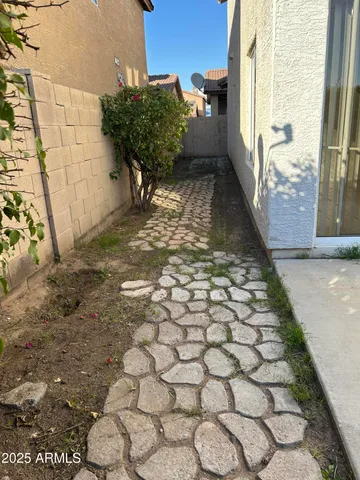 a view of a yard with plants and trees