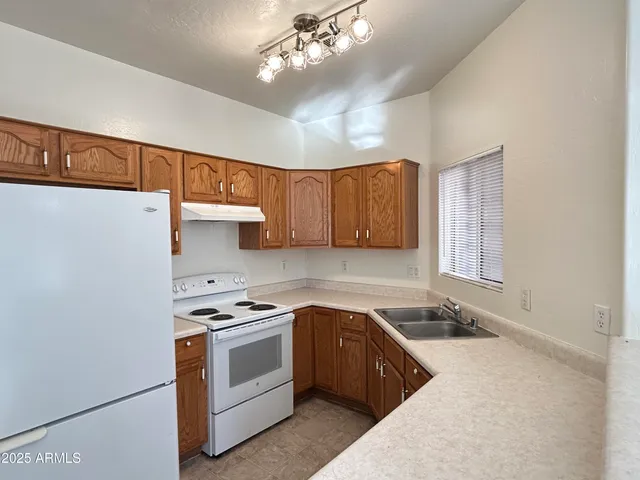 a kitchen with a sink stove and cabinets