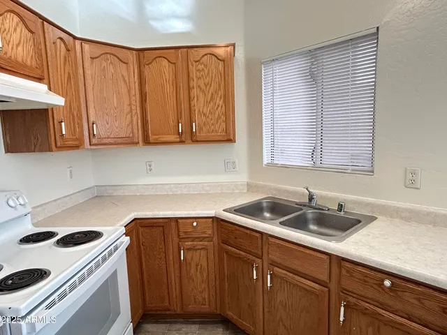 a kitchen with a sink a cabinets and appliances