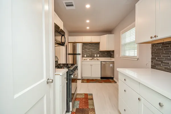 a kitchen with a sink a refrigerator and window