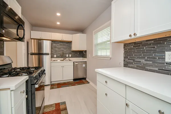 a kitchen with a stove a sink and a refrigerator