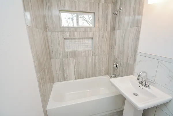 a white bath tub sitting next to a white sink